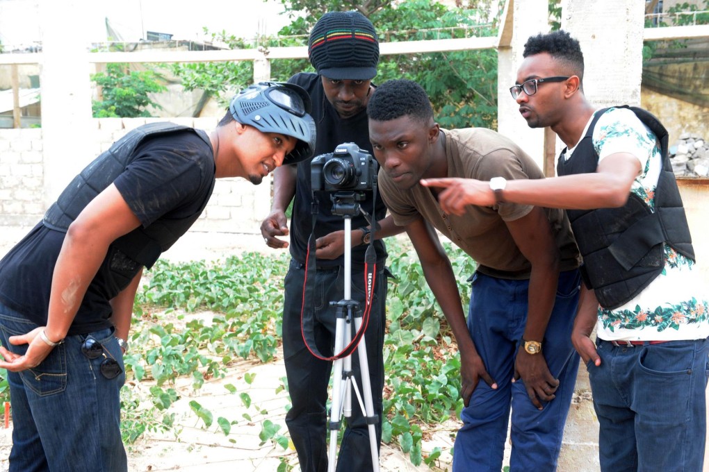 (From left) Senegalese rappers Hyde and Xuman with Elzo Jamdong recording the news programme Journal Tele Rappe. Photo: AFP