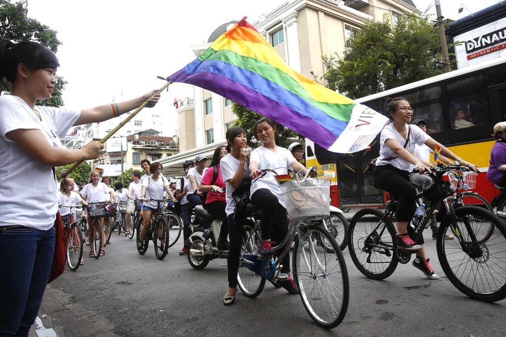 A rainbow flag is waved as the parade passes. Photo: Reuters