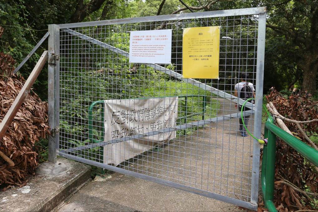 The gate straddling the path to Tai Ho Wan, with warnings not to trespass. Photo: K.Y. Cheng