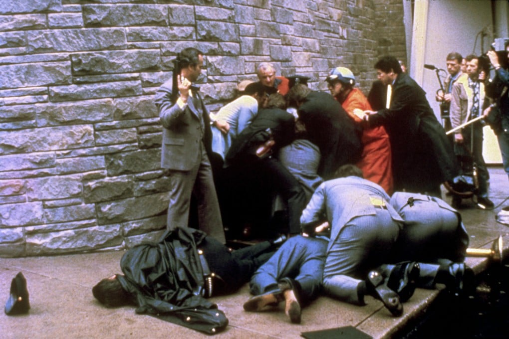 Secret Service agents tend to James Brady (centre front) beside wounded policeman Thomas Delahanty (left) as other agents descend on shooter John Hinckley in the aftermath of the assassination attempt of Ronald Reagan in Washington in 1981. Photo: AP