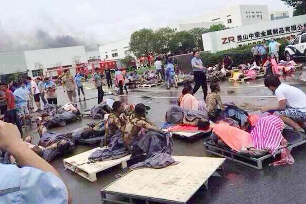 Rescuers help the victims of an explosion at the factory in Kunshan. Photo: Reuters