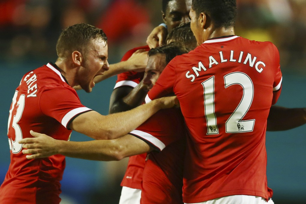 Tom Cleverley celebrates with Juan Mata and Chris Smalling after Mata gave Manchester United the lead in the International Champions Cup. Photo: AP