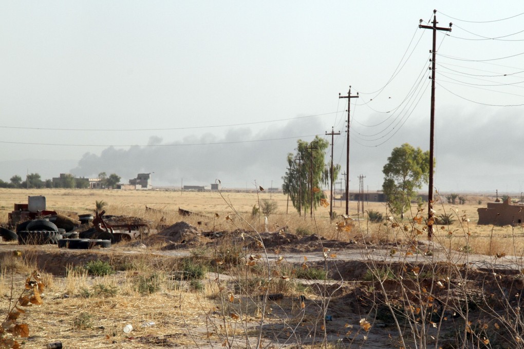 Smoke billows during fighting between Iraqi security forces, backed by Turkmen Shiite fighters, and Islamic State (IS) Sunni militants. Photo: AFP