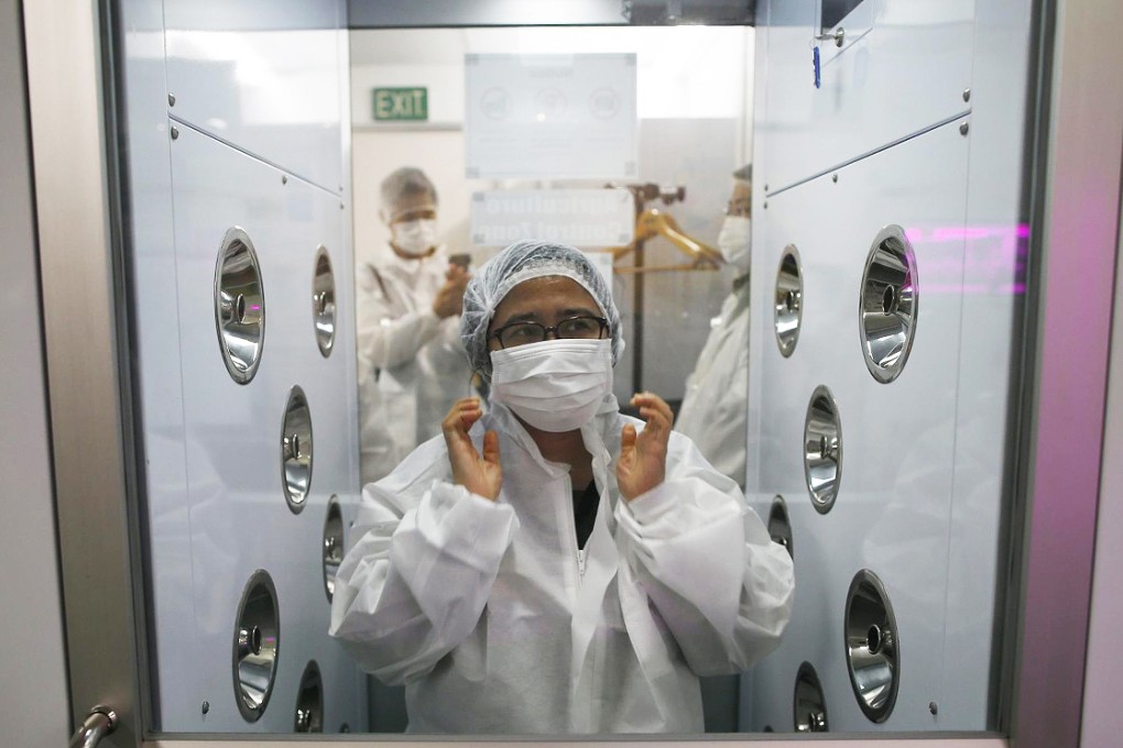 A visitor suits up before entering Panasonic's vegetable farm. Photo: Reuters