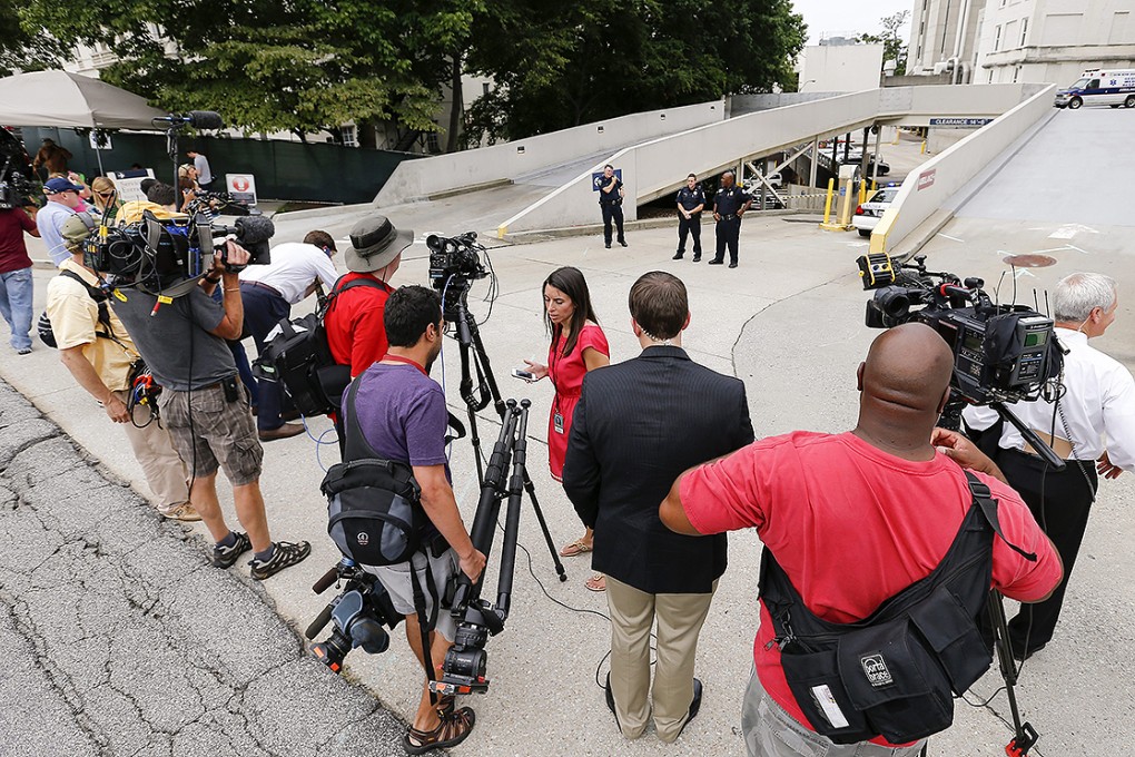 Press gather at the Emory University Hospital in Atlanta as Ebola patient Dr Kent Brantly returned the to US from Liberia on Saturday. Photo: EPA