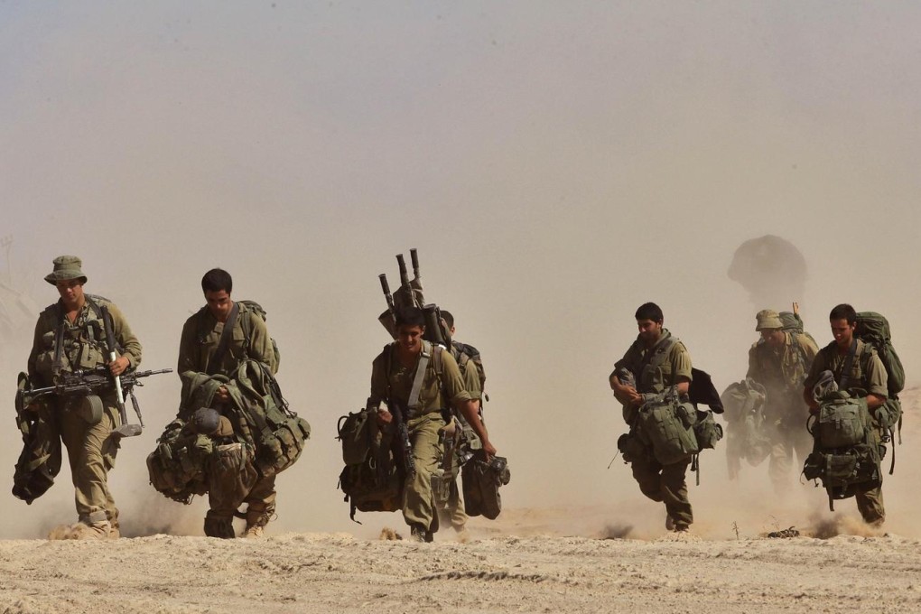 Israeli soldiers return home after the completion of their ground operation in Gaza. But Israel has vowed to retaliate if Hamas breaks the 72-hour ceasefire brokered in Cairo. Photo: AFP