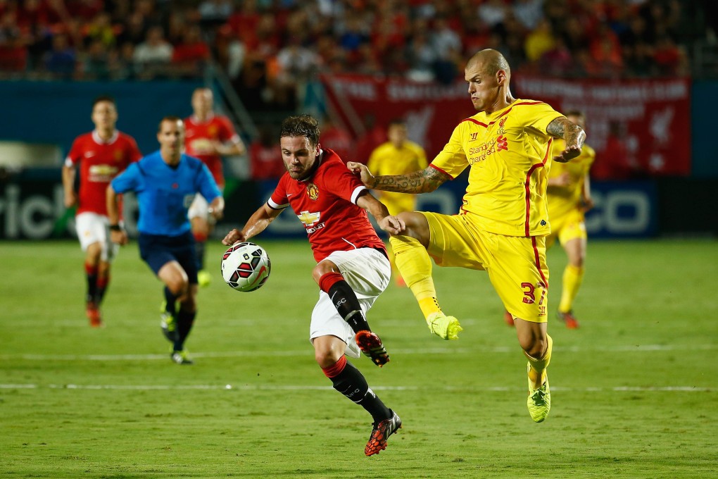 Juan Mata of Manchester United battles with Liverpool's Martin Skrtel in the International Champions Cup final at Sun Life Stadium in Miami Gardens, Florida. Photo: AFP
