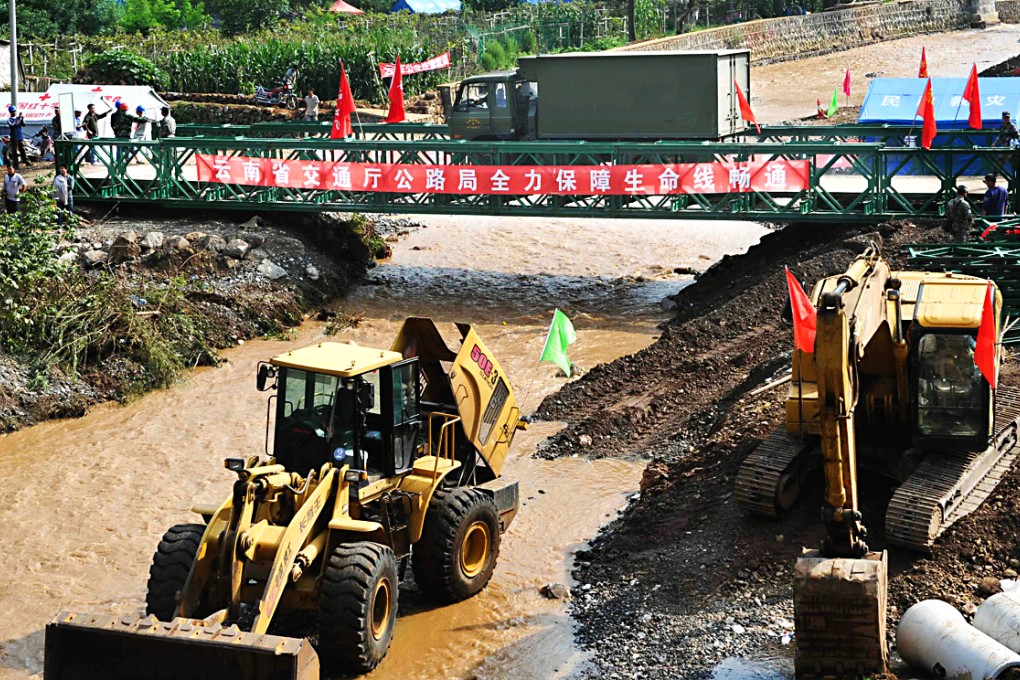 A vehicle runs on a newly built bridge across the Longquan River in Longtoushan. Photo: Xinhua