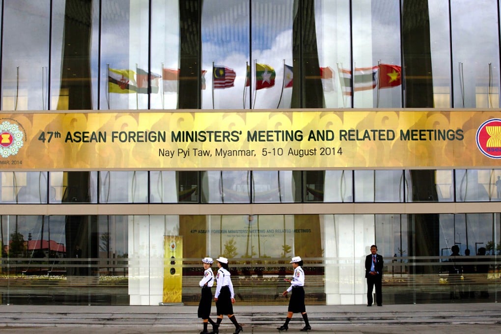 The national flags of Southeast Asian nations are mirrored on the facade of the Myanmar International Convention Centre, the venue for the 47th Asean Foreign Ministers meeting and 21st Asean Regional forum in Naypyidaw on Thursday. Photo: AP