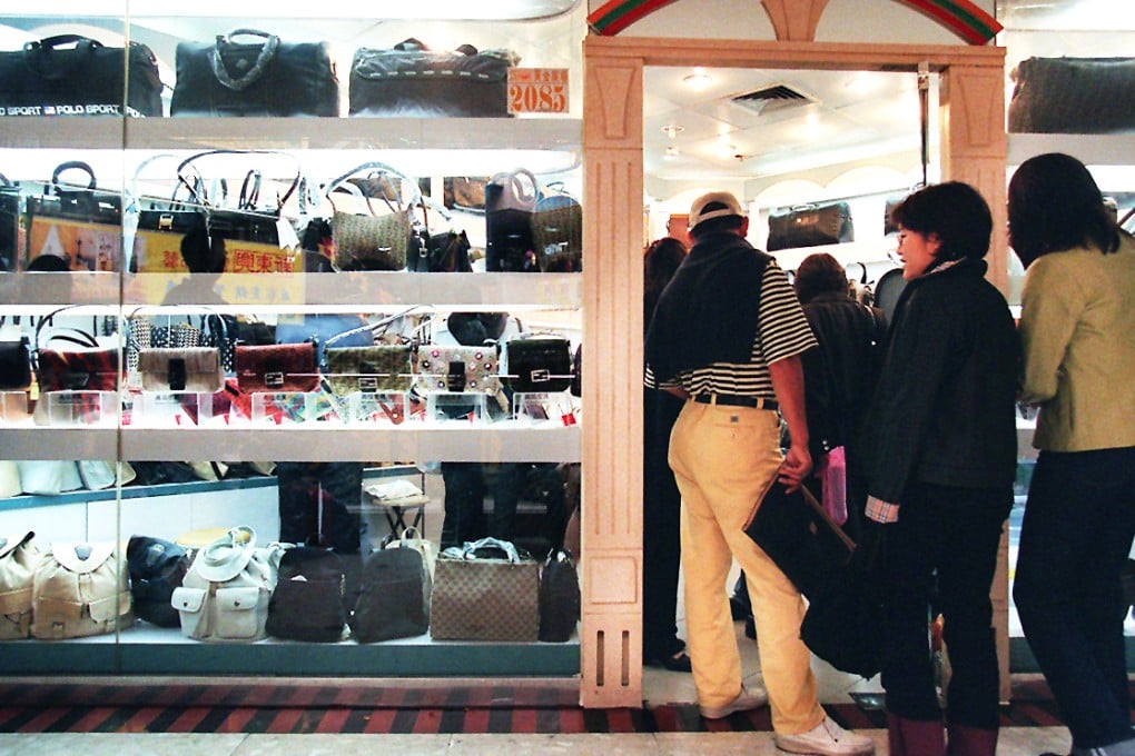 Customers browse counterfeit goods on sale at a store in Shenzhen. Photo: David Wong