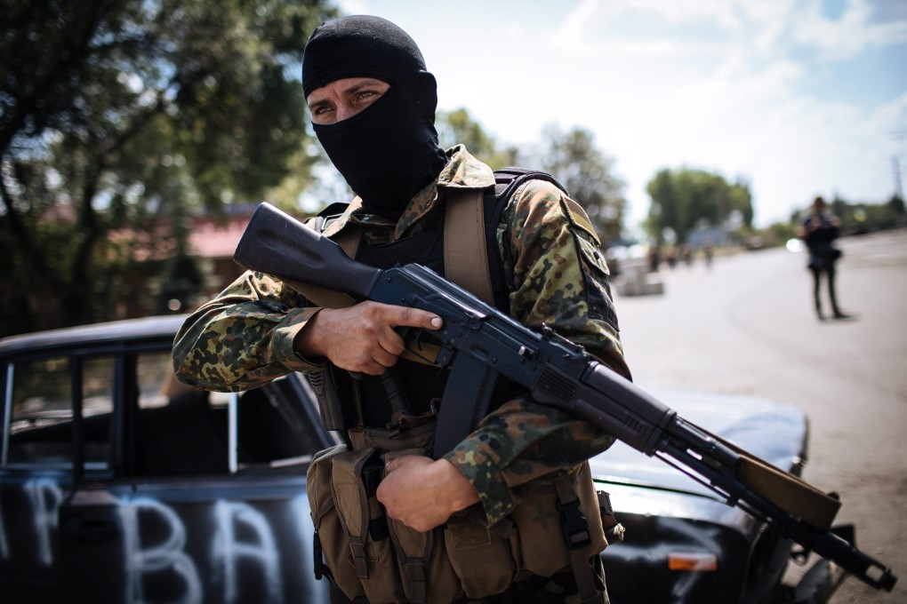 A Ukrainian soldier stands guard at a checkpoint near the eastern Ukrainian city of Debalcevo. Ukraine said its forces were preparing to take control of separatist cities amid Russian build-up. Photo: EPA