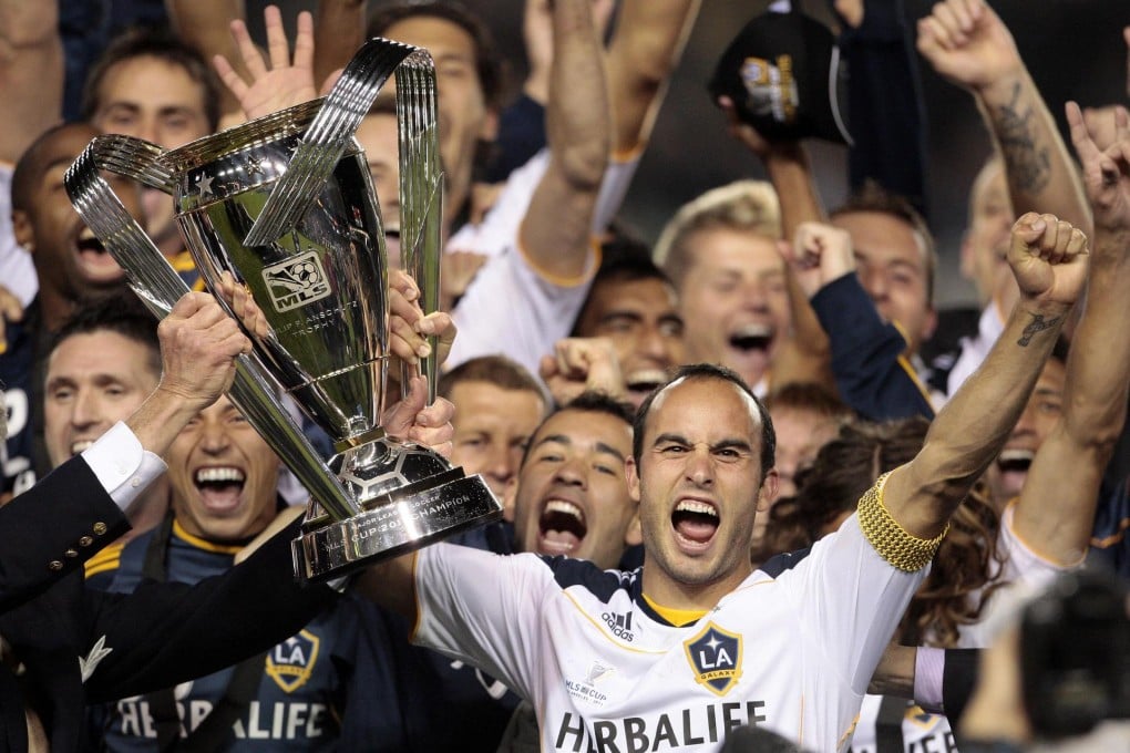 United States star Landon Donovan lifts the MLS Cup he won with Los Angeles Galaxy in 2011. Photo: AP