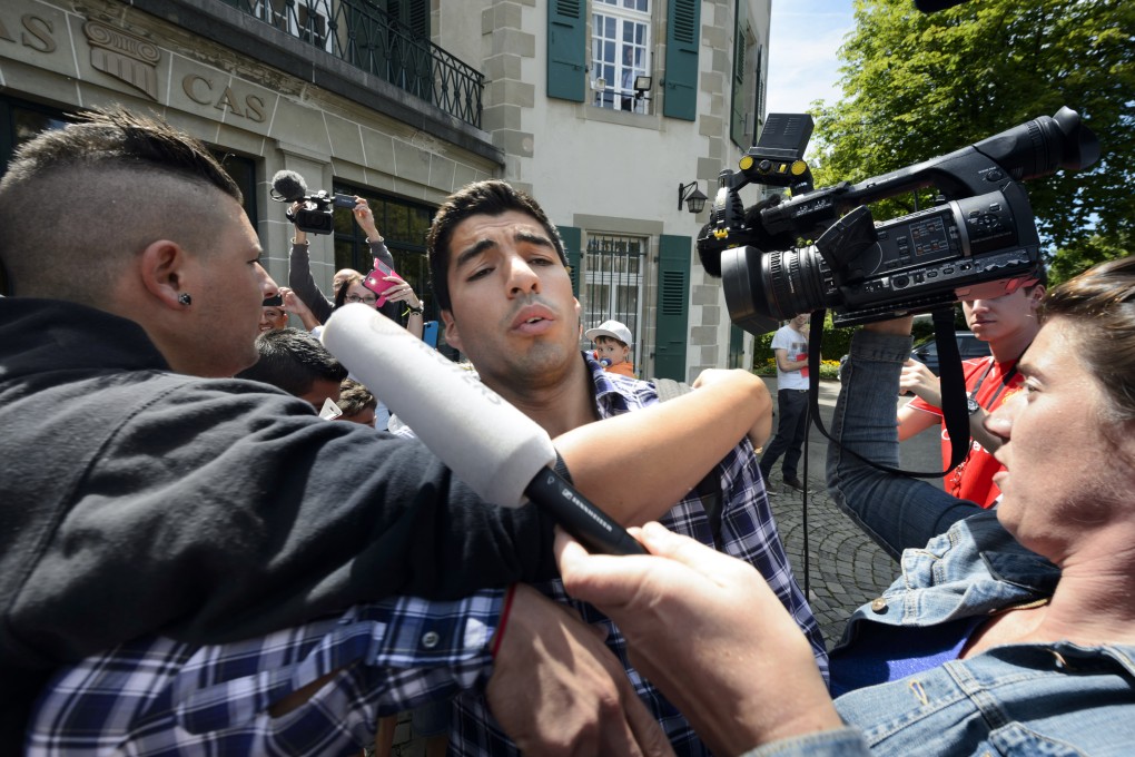 A fan tries to hug Luis Suarez for a selfie as he leaves the Court of Arbitration for Sport in Lausanne, Switzerland. Photo: AP