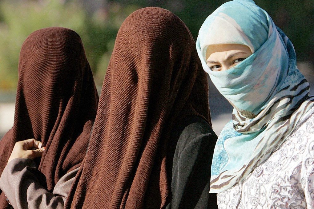A city in Xinjiang has banned the wearing of Islamic veils and dresses, along with long beards, over security concerns during a sporting event. After a backlash, the government explained the Islamic clothing were 'cumbersome' for sports. Photo: AFP
