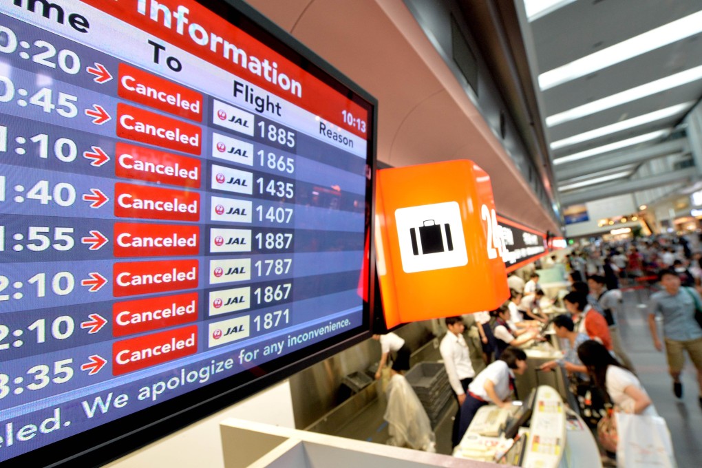 A flight information board displays cancelled flights due to Typhoon Halong at Tokyo's Haneda airport on Saturday. Photo: AFP