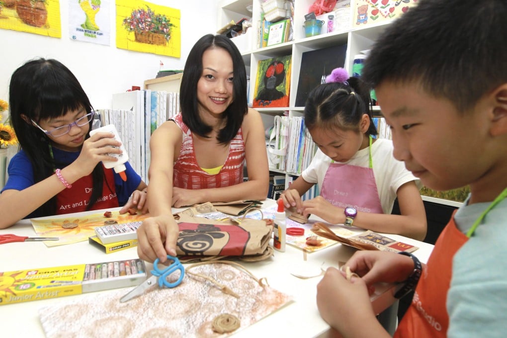 Agnes Pang shows (from left) Megan Lau, Venus Yeung and Dicky Wu how to create works of art using recycled materials. Photos: Edward Wong