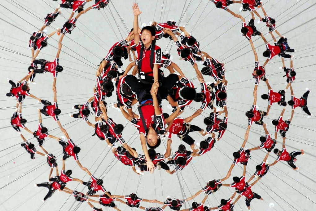 Student performers rehearse a stunt for the opening ceremony of 2014 Nanjing Youth Olympic Games to be held on Saturday. Photo: Reuters