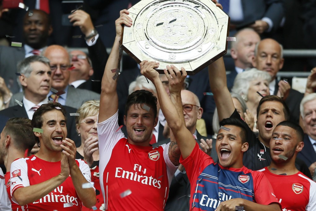 Arsenal teammates with Olivier Giroud (centre left) and Alexis Sanchez celebrate winning the Community Shield on Sunday. Photo: AP