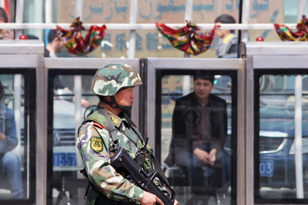 Armed police stand guard in Xinjang in May. Officials blame Islamist militants and separatists for a series of violent attacks in the past few years. Photo: Simon Song