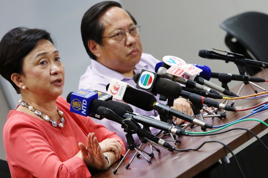 Emily Lau and predecessor Albert Ho discuss the results of the party's eight-hour meeting on political reform yesterday. Photo: Nora Tam