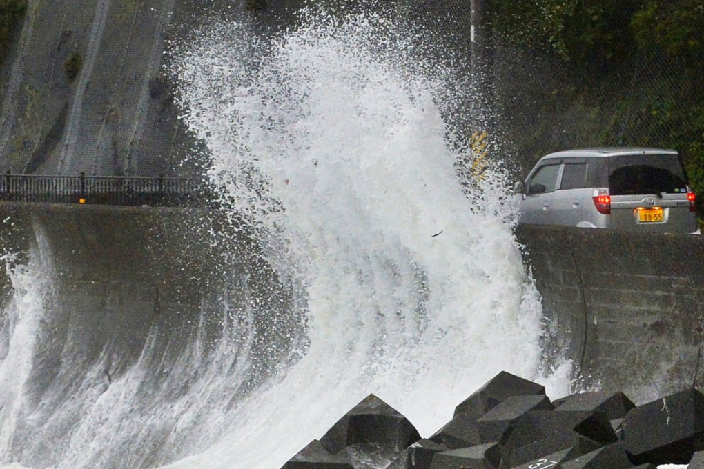 Typhoon Halong is lashing Japan as it enters a holiday week, injuring six people and causing authorities to order the evacuation of half a million people near swollen rivers. Photo: AP