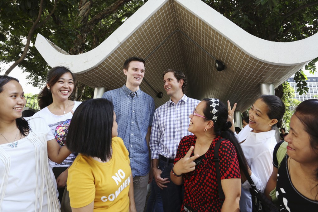 Scott Stiles (left) and David Bishop (right), co-founders of the Fair Employment Agency, with domestic helpers. Photos: Nora Tam; Sam Tsang; Thomas Yau