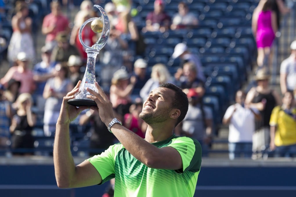 Jo-Wilfried Tsonga lifts the trophy after beating  Roger Federer  to win the  Rogers Cup. Photo: AP