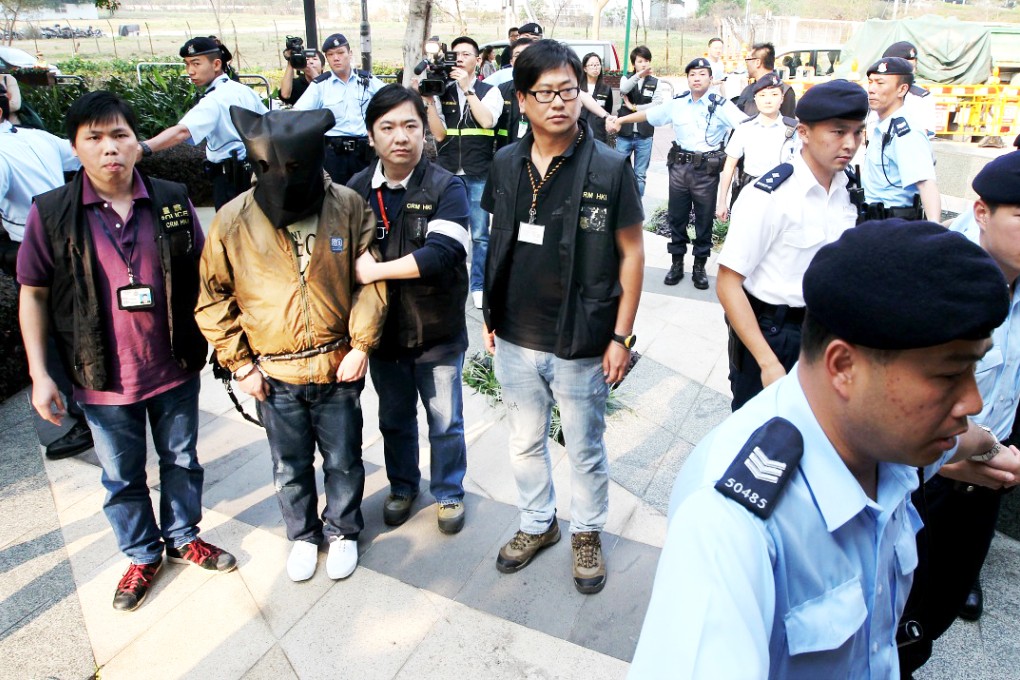 Tse Chun-kei is escorted by police in Tai Kok Tsui after his arrest last year. Photo: Felix Wong