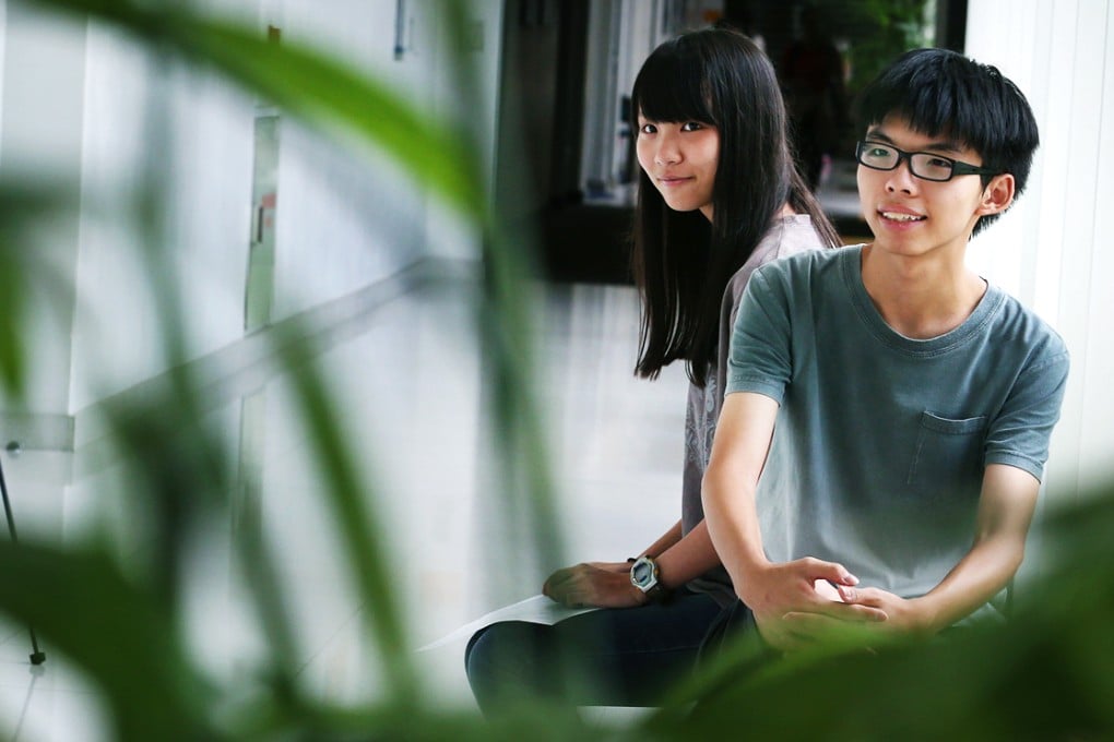 Scholarism spokeswoman Agnes Chow Ting (left), and convenor Joshua Wong Chi-fung, meet the press after received their results of the Diploma of Secondary Education examinations.  Photo: Felix Wong