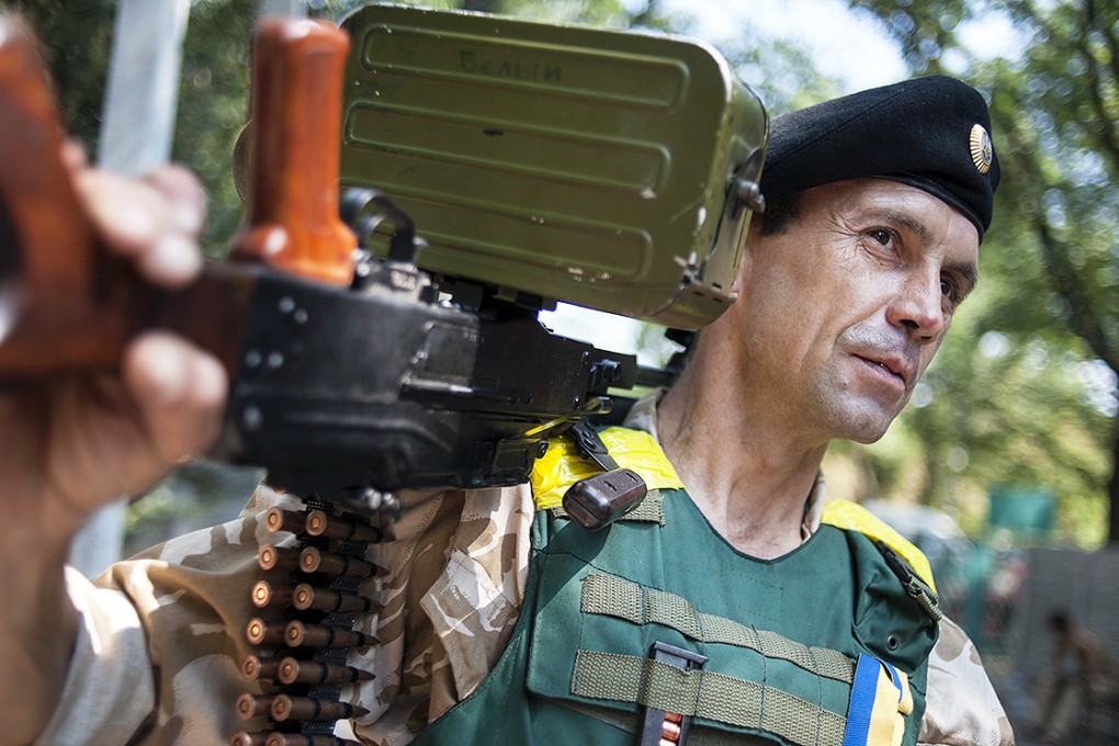 A Ukrainian government soldier from the "Donbass" battalion guards a position in the village of Marinka, near Donetsk, eastern Ukraine. Photo: AP