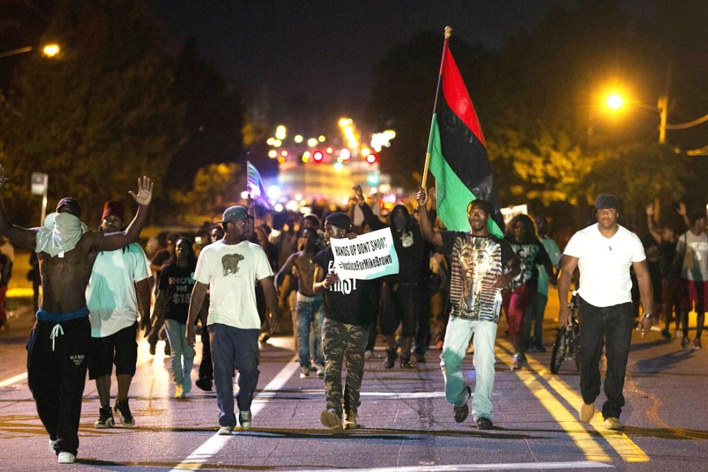 Demonstrators march to protest the shooting to death of black teenager Michael Brown in St Louis. Photo: Reuters