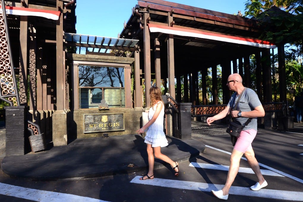 This photo taken on August 12, 2014 shows foreign tourists walking past the St. Regis hotel in Nusa Dua. Photo: AFP