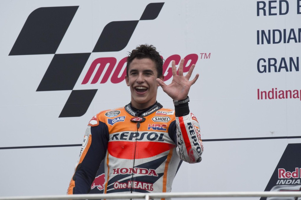 Marc Marquez of Spain celebrates on the podium after winning at Indianapolis for his 10th victory in a row this season. Photo: AFP