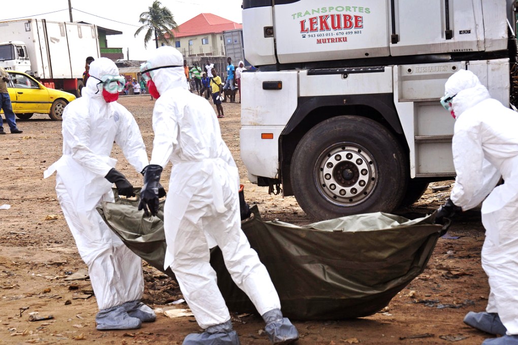 The body of a suspected victim is picked up in Liberia. Photo: AP