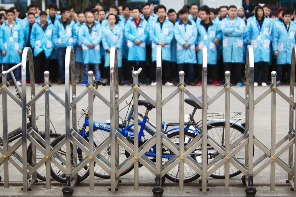 Workers protest at an IBM factory in Shenzhen, Guangdong on March 7. Photo: Reuters