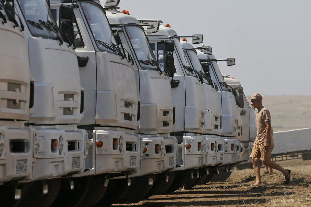 A Russian convoy carrying humanitarian aid stops near the Ukraine border. Kiev is wary about what the trucks are carrying. Photo: Reuters