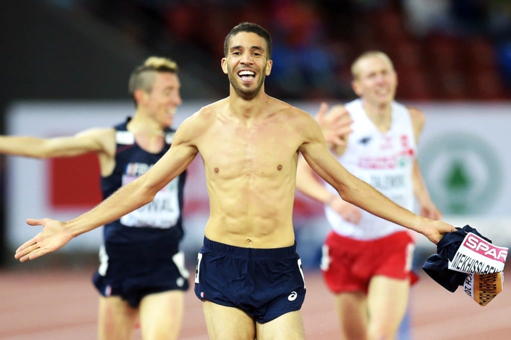 Mehkissi-Benabbad strips off his vest before being stripped of his medal. Photo: EPA