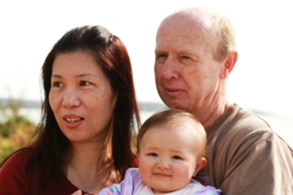 David Farnell and his wife Wendy pose with their baby Pipah in Australia. The Australian couple has denied that they abandoned their son born with Down syndrome to a Thai surrogate. Photo: AP/60 Minutes