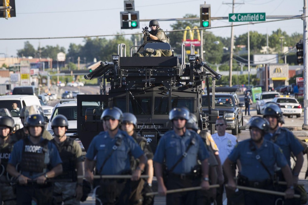 A former military vehicle at a police line in Ferguson. Photo: Reuters