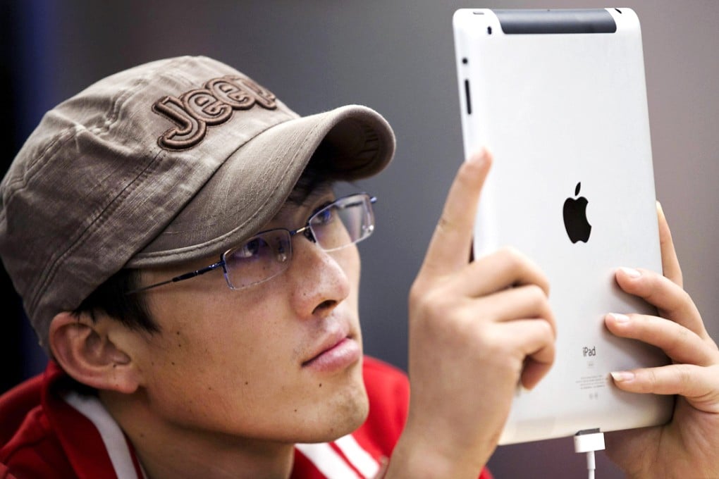 An Apple customer at one of its stores in Beijing. Photo: AP