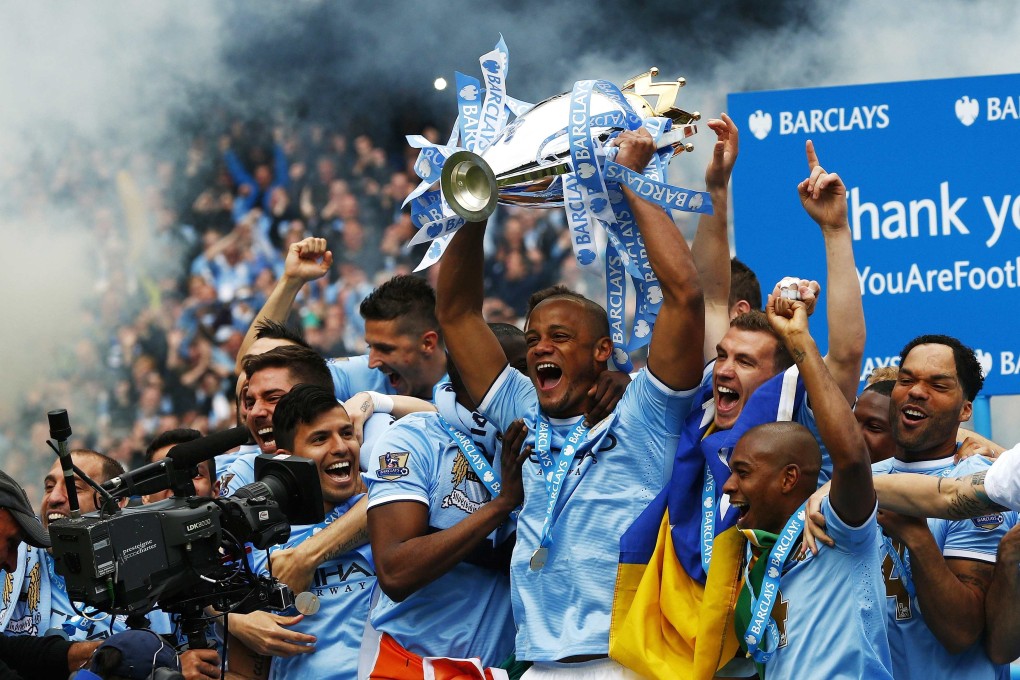 Manchester City players celebrate winning last season's English Premier League title. Will they accomplish the feat a third time in four seasons? Photo: Reuters