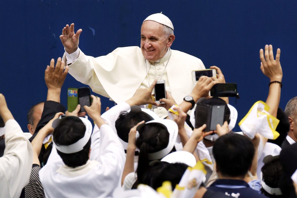 Pope Francis is greeted by followers as he arrives to attend a mass at Daejeon World Cup Stadium on August 15. Photo: AFP