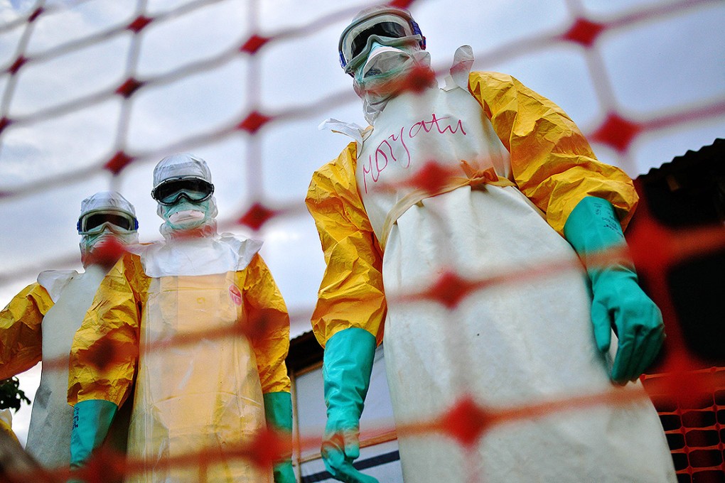 Medecins Sans Frontieres medical staff wearing protective clothing treat the body of an Ebola victim at their facility in Kailahun, Sierra Leone. Photo: AFP