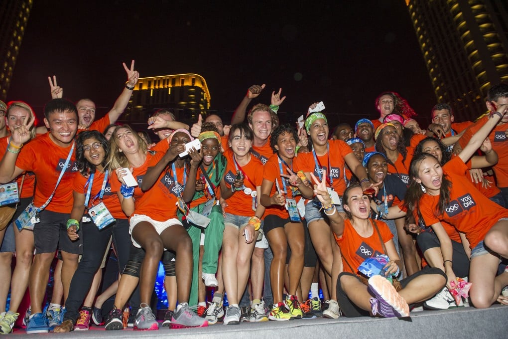 Athletes take photos at a welcome party in the Youth Olympic Village in Nanjing. Photo: Xinhua