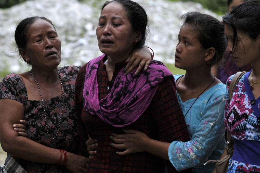 Nepalese villagers grieve following the deaths of family members in a landslide at Lamo Sanghu on the Sukoshi river, some 80 kilometres northeast of Kathmandu. Photo: AFP