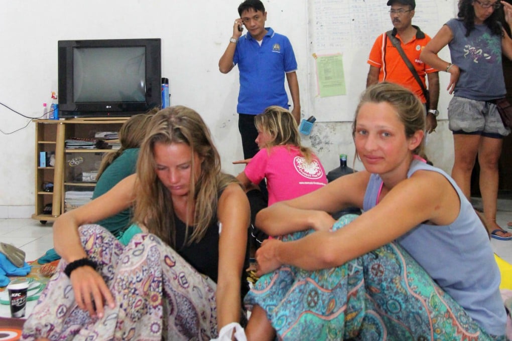 Survivors rescued after a tourist boat sank rest at a house near to the Indonesian town of Bima on Sunday. Photo: AFP