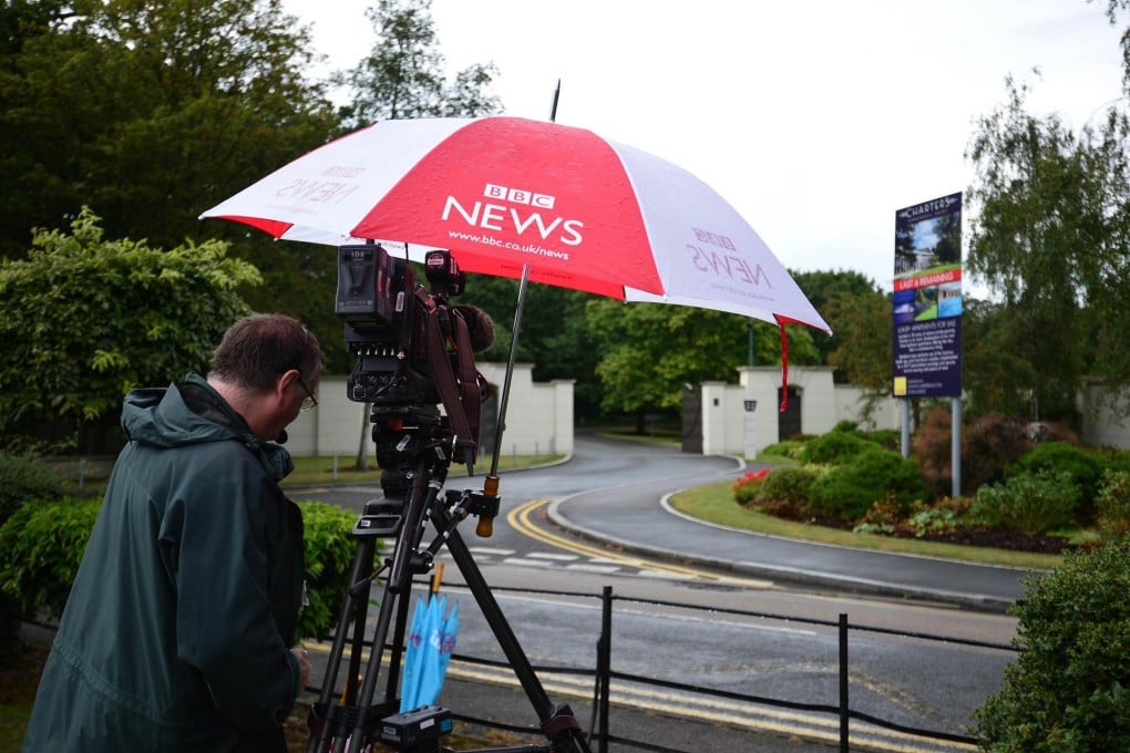 A cameraman at an estate in Sunningdale, west of London, in which British pop singer Cliff Richard also owns an apartment. Photo: AFP
