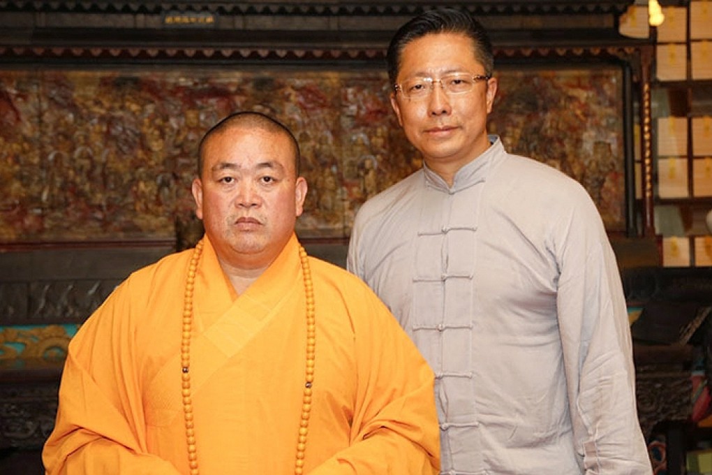 “Crazy English” founder Li Yang (right) posts for a photo with Shao Lin Temple abbot, Shi Yongxin. Photo: SCMP Pictures