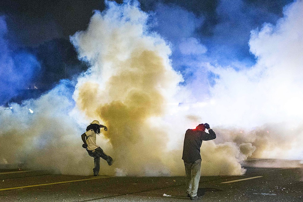 A protester kicks a tear gas canister back towards police amid ongoing protests in Ferguson, Missouri. Photo: Reuters