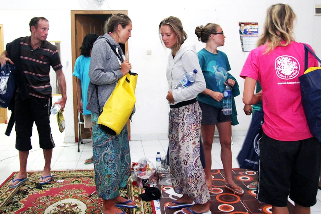 Survivors rescued after a tourist boat sank prepare to move to a hotel near to the Indonesian town of Bima on Sunday. Photo: AFP